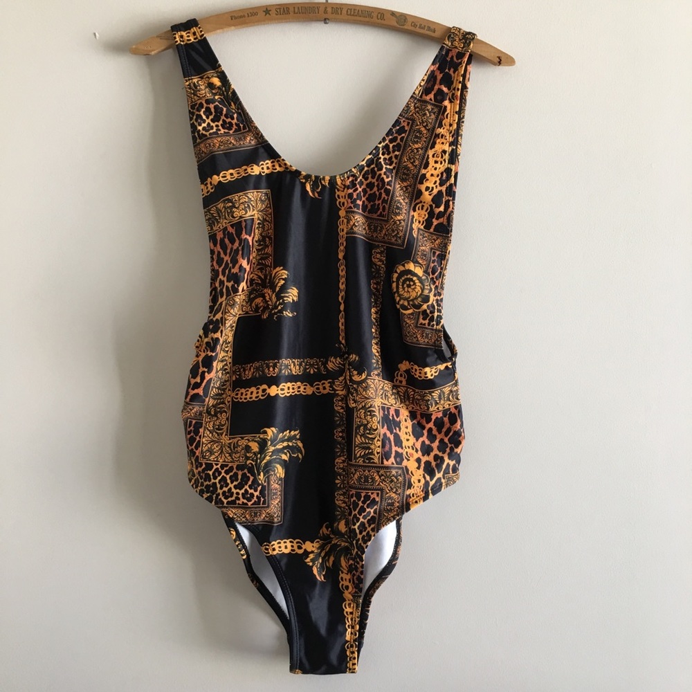 Gold chain, cheetah print and black bodysuit